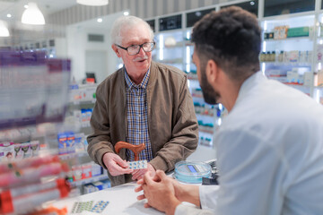 Young pharmacist explaining to customer how to dosing medication.