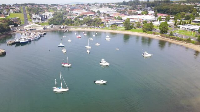 Aerial drone view of Ulladulla in the City of Shoalhaven, NSW, Australia, descending on Ulladulla Harbour 