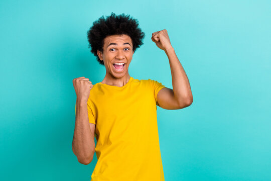 Photo of ecstatic cheerful guy dressed yellow t-shirt shouting yeah celebrate winning isolated on bright turquoise color background