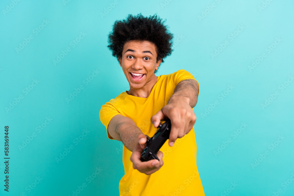 Sticker portrait of overjoyed positive young man hold gamepad have fun playing games isolated on aquamarine 