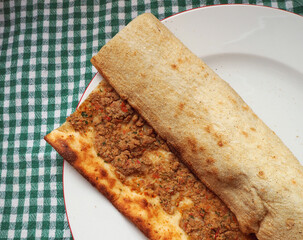 Pita with minced meat from traditional Turkish pastries (Kıymalı pide). Ingredient with minced meat, onion, tomato and pepper.