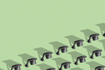 Pattern with black graduated cap on green background with copy space. Education background