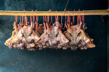 Northern Vietnam, Dehydrated smocked pig heads for sale in a local market. - obrazy, fototapety, plakaty