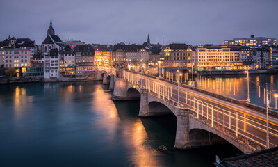 Panorama of the city with old houses in the city center and bridge at water during evening