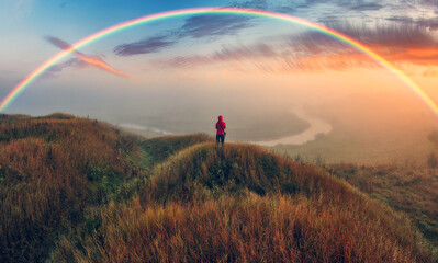 Woman Looking At Rainbow. rainbow over the autumn river. nature of Ukraine