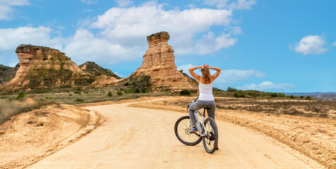 Woman biking in Spain,  Aragon,  Monegros desert