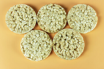 Five wheat crumbs on an orange background