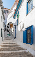 Narrow street with steps in the old town of Hydra, Greece.