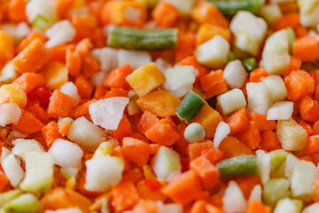 Vegetables mixture of chopped, frozen vegetable string beans, carrots, pumpkin, green peas, close-up, selective focus