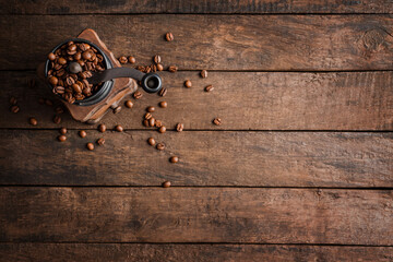 Wooden background with rustic coffee gringer