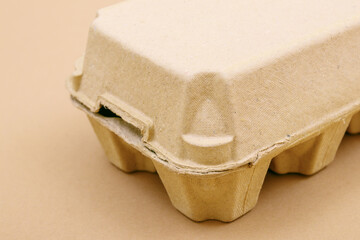 Closed egg box with ten eggs. Close carton pack or egg container. Egg box with chicken eggs, carton pack or egg container. Close up, macro shot.