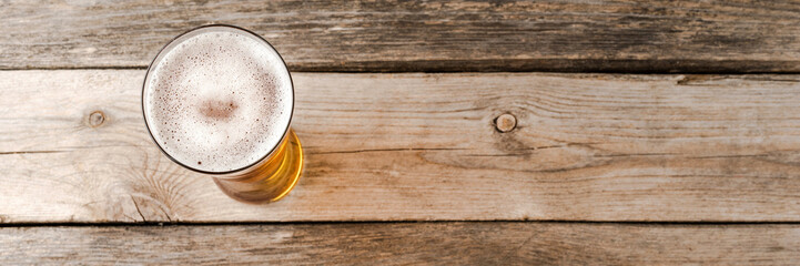 Beer glass on wooden table. Close up