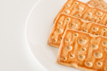 Rectangular sweet cookies, on white plate, top view, selective focus