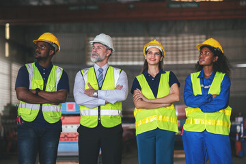 Group of diverse people, Factory worker teamwork, Cooperation in factory with engineers and technician work together on heavy industrial project.
