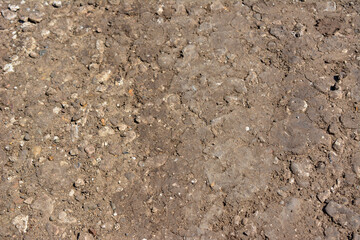 A close up of a dirt ground with rocks, dirty soil and pebbles isolated