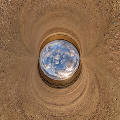 blue sphere little planet inside gravel road or field background. curvature of space