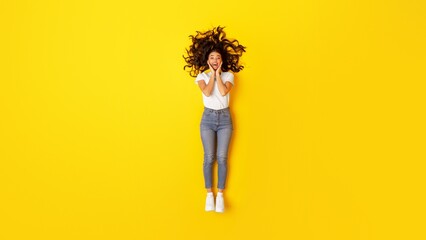 Fototapeta na wymiar Excited Woman Touching Face Looking At Camera Over Yellow Background
