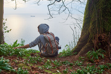  man in the forest touching a plant