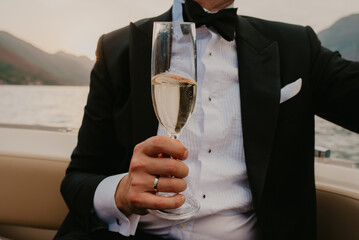 bride and groom newlyweds drinking champagne wine on boat on wedding day sunset romantic boho 