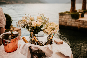 bride and groom newlyweds drinking champagne wine on boat on wedding day sunset romantic boho 
