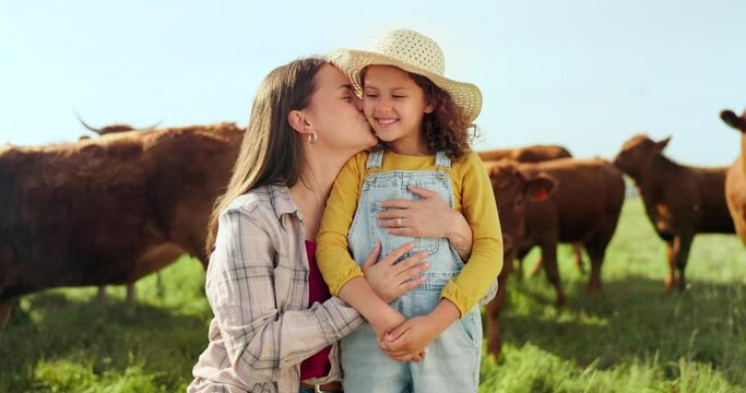 Farming, child and mother with kiss on a farm during holiday in Spain for sustainability with cattle. Portrait of happy, smile and travel mom and girl with love while on vacation on land with cows