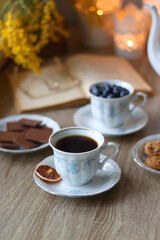 Cup of tea or coffee, plate of cookies, cup of blueberries, plate of chocolate, glass of juice,...