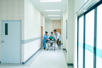 Doctor team and nurse staff carrying stretcher with patient from the accident ambulance running to the surgery room in hospital