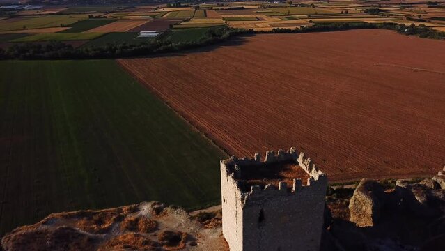Drone pull-out view over the ruins of Castillo de Oreja on a sunny day