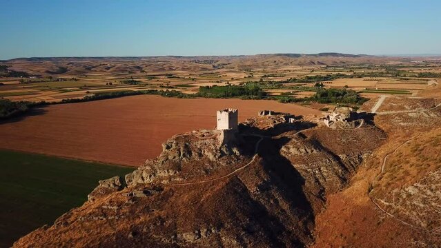 Drone view of the ruins of Castillo de Oreja before a blue skyline