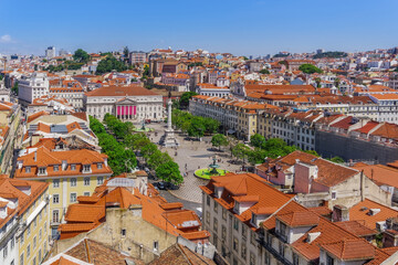 Obraz premium Lisbon, Portugal panoramic landscape of Dom Pedro IV square, Praca Dom Pedro IV, with column surrounded by traditional low-rise red tile rooftop buildings and Teatro Nacional D. Maria II.