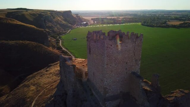 Drone pull-out view over the ruins of Castillo de Oreja on a sunny day