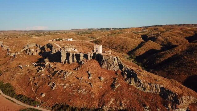Drone view of the ruins of Castillo de Oreja before a blue skyline