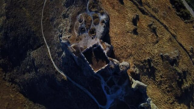 Drone rising view over the ruins of Castillo de Oreja on a sunny day