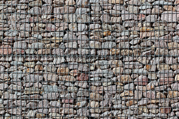 Gabion fence wall from steel mesh with stones on german street. Gabion wire mesh fencing.