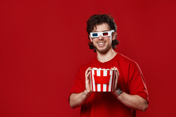 man in 3d glasses holding big bucket of popcorns © Rychko Yevhen