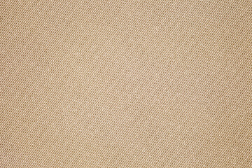 Beige fabric close-up, small stitches of thread, background wallpaper, uniform texture pattern