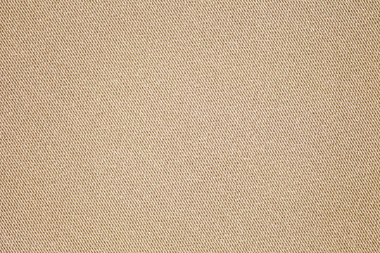 Beige fabric close-up, small stitches of thread, background wallpaper, uniform texture pattern