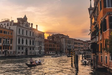 Fototapeta na wymiar Beautiful shot of historic buildings on the shore of the canal with a gondola in Venice, Italy