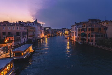 Aerial view of illuminated lights on the shore of the canal in Venice, Italy
