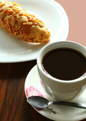 Brazilian breakfast with coffee cup and bread.