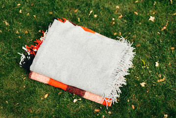 background plaid on green grass for picnic оr outdoor recreation