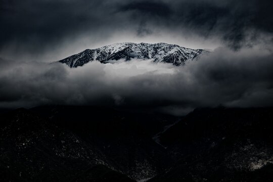 Black and white drone shot of Glendora Mountain in California covered with clouds