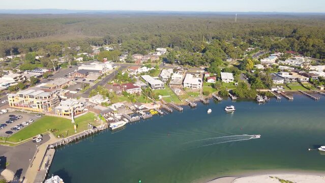 Aerial drone view of Huskisson in the City of Shoalhaven on the shores of Jervis Bay, NSW, Australia, showing Currambene Creek on a bright sunny morning   
