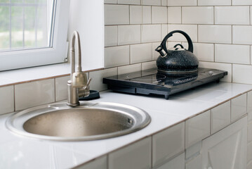 Boiling water in the kettle - the kitchen in the morning.