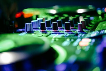 Closeup of a unique dj console and dj's hands controling it at a party