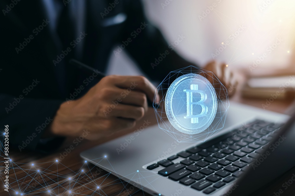 Poster bitcoin symbol and network signs in the air with a hand typing on a computer in the background