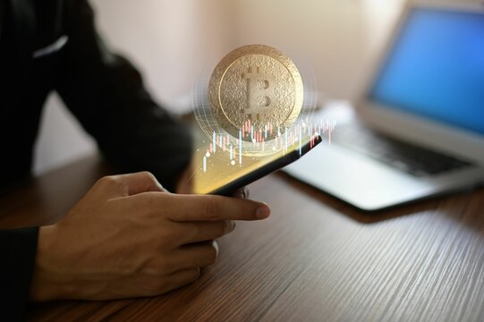 Bitcoin symbol and a phone - the concept of cryptocurrency and trading