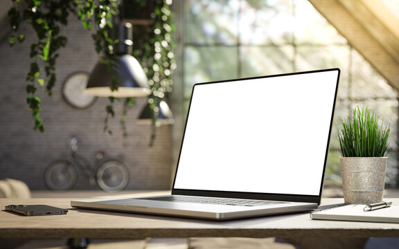 Laptop with blank frameless screen mockup template on the table in industrial office loft interior - angled view. 3d render
