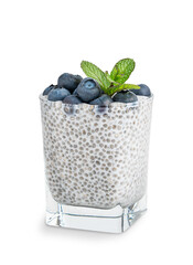 Sweet homemade pudding dessert made of healthy organic chia seeds soaked in natural plant based milk decorated with topping of blueberries and mint leaf served in glass isolated on white background