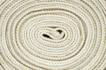 Elastic bandage twisted into coil in spiral close-up full depth of field